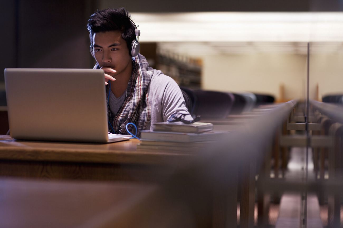 A student typing on a laptop
